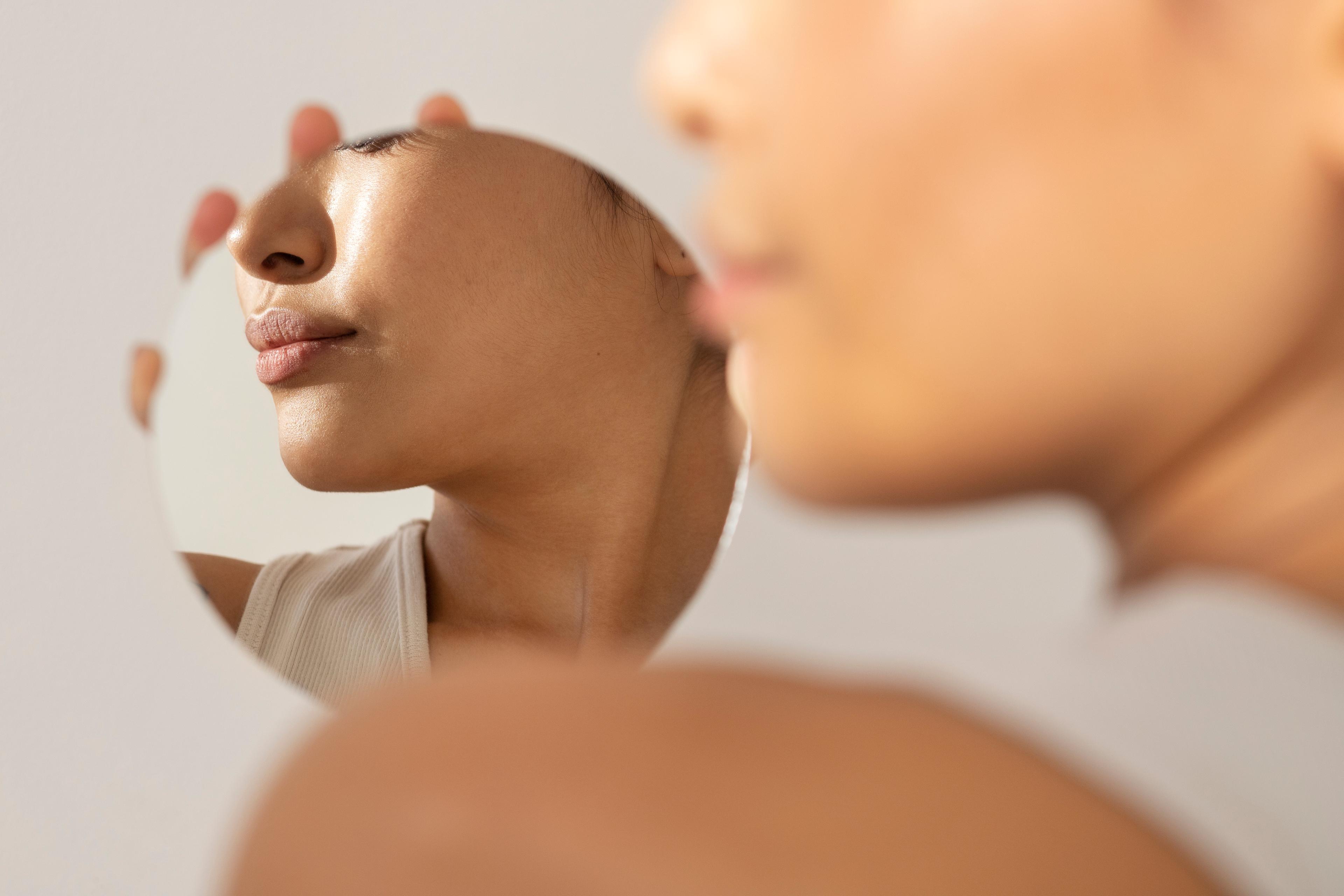 beautiful asian woman posing with facial cream